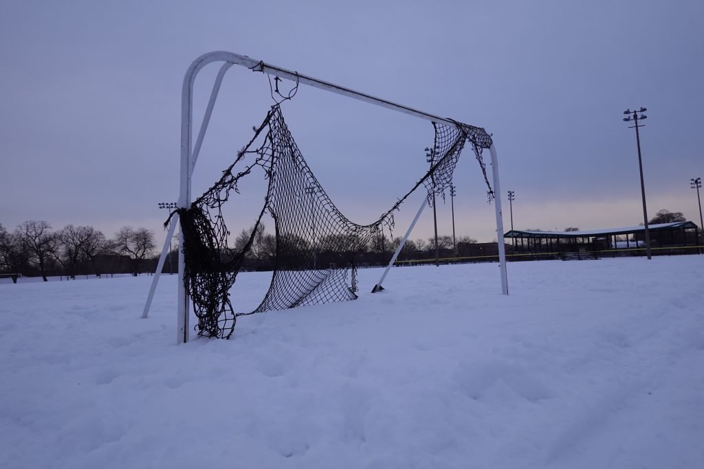 soccer net in snow-covered field