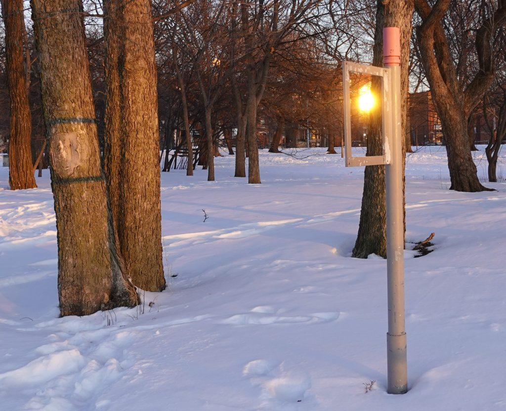 sun reflection through a broken sign